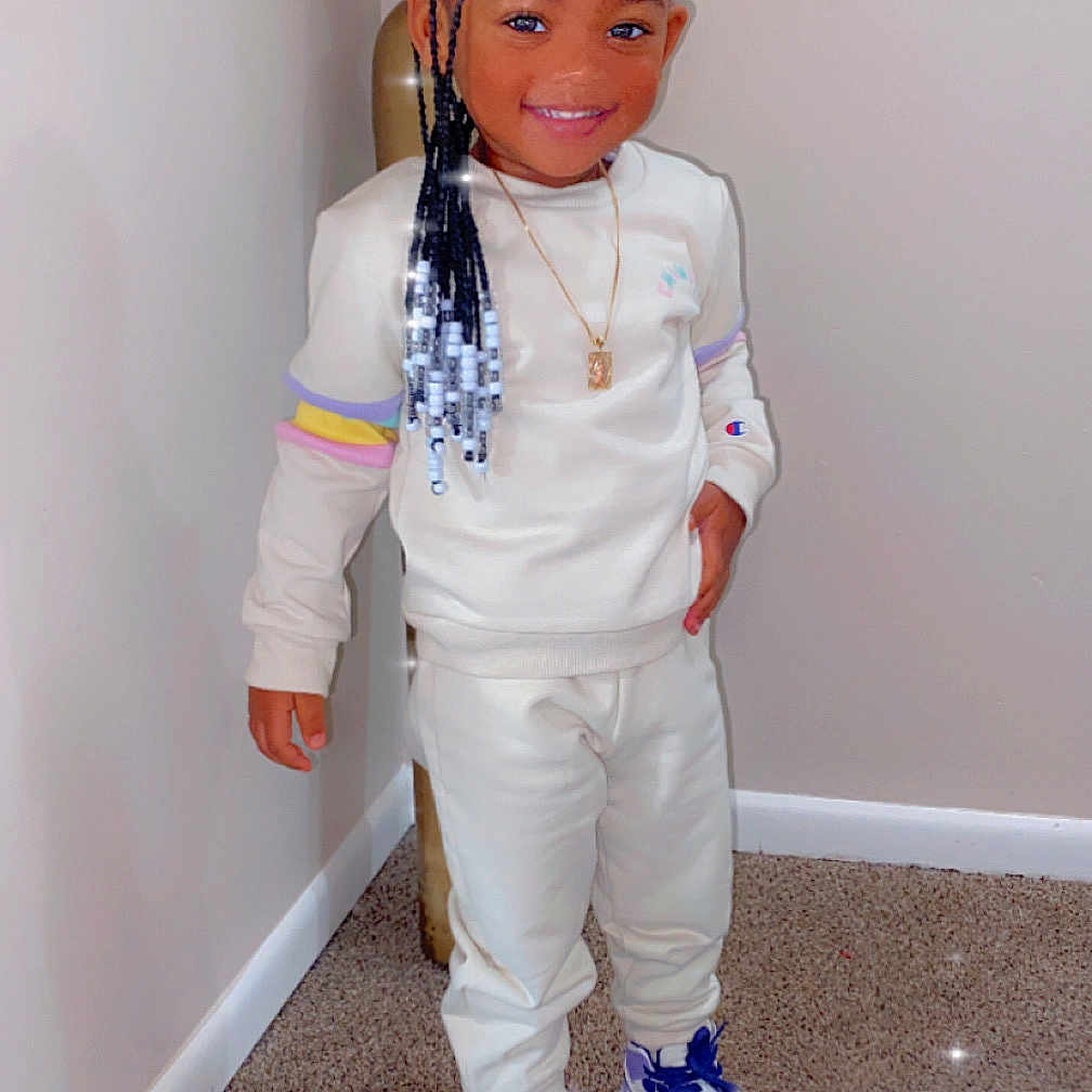 Malani is registered to the contest to win money with this photo: accessories, boy, child, clothing, face, footwear, formalwear, hair, head, jewelry, male, necklace, pants, person, photography, portrait, shoe, sneaker, standing, wood