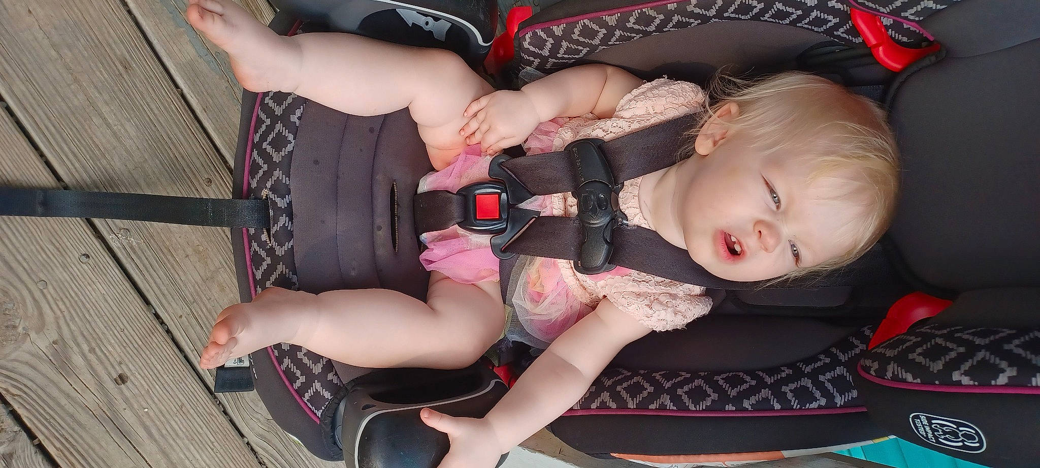 Madalyn is registered to the contest to win money with this photo: arm, baby, baby_carriage, baby_products, baby_toddler_clothing, chest, comfort, fun, hand, human_leg, knee, lap, leg, nail, pattern, person, pink, sitting, thigh, toddler