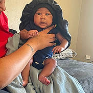 Zyaire is registered to the contest to win money with this photo: baby, bed, bedroom, blanket, clothing, cushion, face, furniture, hat, head, homedecor, indoors, newborn, people, person, photography, portrait, room, skin, tattoo