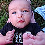 Delilah is registered to the contest to win money with this photo: baby, infant, child, face, foot, hand, grass, outdoor, pink_pants, black_shirt, blue_eyes, person, nature, cute, skin, expression, closeup, playing, legs, summer
