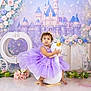 toddler, child, dress, lavender, tutu, plush_toy, rocking_swan, crown, flower_crown, castle_backdrop, fairy_tale, flowers, decor, indoor, portrait, cute, baby, smile, floor, playful