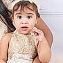 toddler, child, lace_dress, headband, jewelry, bracelet, rings, adult_arm, white_background, portrait, curious_expression, sitting, baby, closeup, female, skin, hand, foot, elegant, indoor