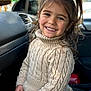 Mia participe au concours pour gagner de l'argent avec cette photo : child, girl, smiling, pigtails, sweater, beige, knitwear, cable_knit, portrait, car_interior, seat, happy, young, cute, face, person, clothing, long_hair, casual, indoor