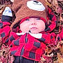James is registered to the contest to win money with this photo: baby, child, hat, bear_hat, red_jacket, checkered, autumn_leaves, fall, outdoor, cute, face, person, gloves, nature, seasonal, young_child, leaf_litter, cozy, infant, portrait