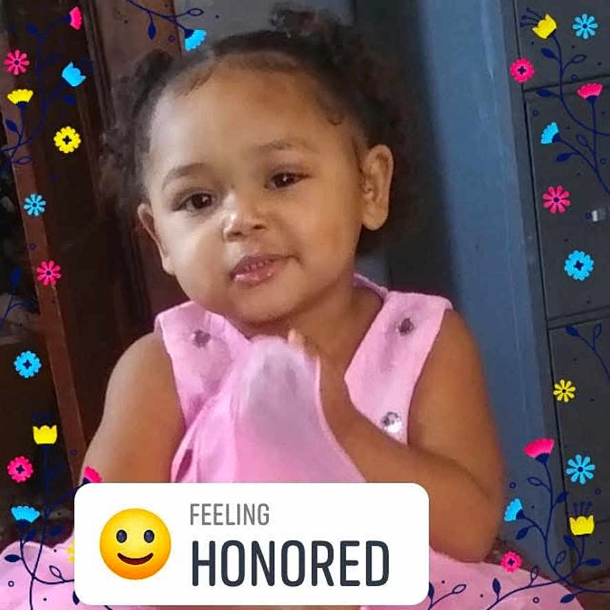 Nayeli is registered to the contest to win money with this photo: child, toddler, pink_dress, smiling, face, portrait, colorful, flowers, emoji, text_overlay, indoor, cute, happy, person, young_child, doodle, clothing, sitting, expression, decorative