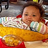 Nayeli joined the competition — help win amazing prizes! baby, child, indoor, curly_hair, blanket, toy, walker, face, person, clothing, colorful, expression, gaze, hand, table, floor, chair, background, home, comfort
