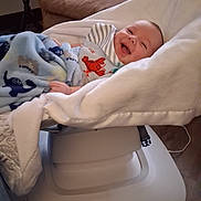 Brendan joined the competition — help win amazing prizes! baby, baby_rocker, blanket, child, clothing, comfort, cozy, cushion, cute, face, furniture, happy, home, indoor, infant, lying_down, person, relaxation, smile, wrapped