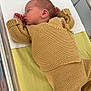 Elyo participe au concours pour gagner de l'argent avec cette photo : newborn, baby, sleeping, bassinet, hospital, knitted_clothing, beige, infant, peaceful, cute, small, face, hand, bed, blanket, soft, resting, child, person, indoors