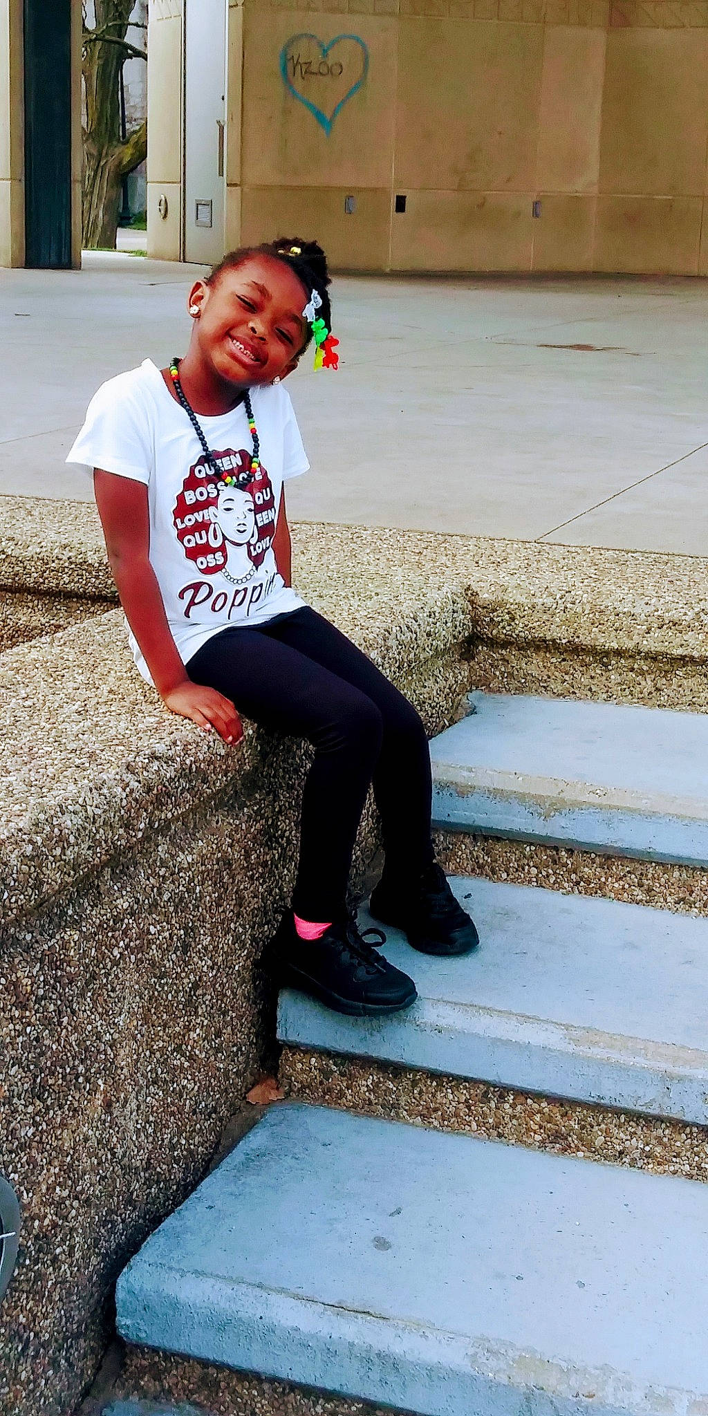 Odyssey is registered to the contest to win money with this photo: concrete, eye, eyewear, face, hair, happy, head, human_leg, joy, knee, leg, leisure, person, recreation, sleeve, smile, sportswear, stairs, street_fashion, t_shirt