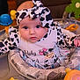 Journey joined the competition — help win amazing prizes! baby, infant, child, cow_print, headband, activity_center, toy, cushion, clothing, face, eyes, indoor, cute, portrait, colorful, playtime, seat, expression, looking, soft_lighting