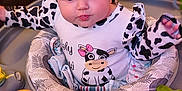 Journey joined the competition — help win amazing prizes! baby, infant, child, cow_pattern, headband, toy, play_area, baby_seat, colorful, cute, curious, indoors, clothing, pink_bow, face, hands, expression, soft_lighting, close_up, young_child