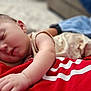 baby, sleeping, infant, closeup, arm, red_shirt, blanket, cushion, indoor, comfort, peaceful, rest, person, skin, head, face, clothing, soft, nap, toddler