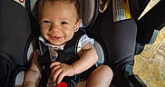 Wesley joined the competition — help win amazing prizes! baby, baby_toys, car_seat, child, child_safety, clothing, cute, face, happy, head, indoor, infant, infant_care, person, seatbelt, sitting, smiling, socks, toy, young_child