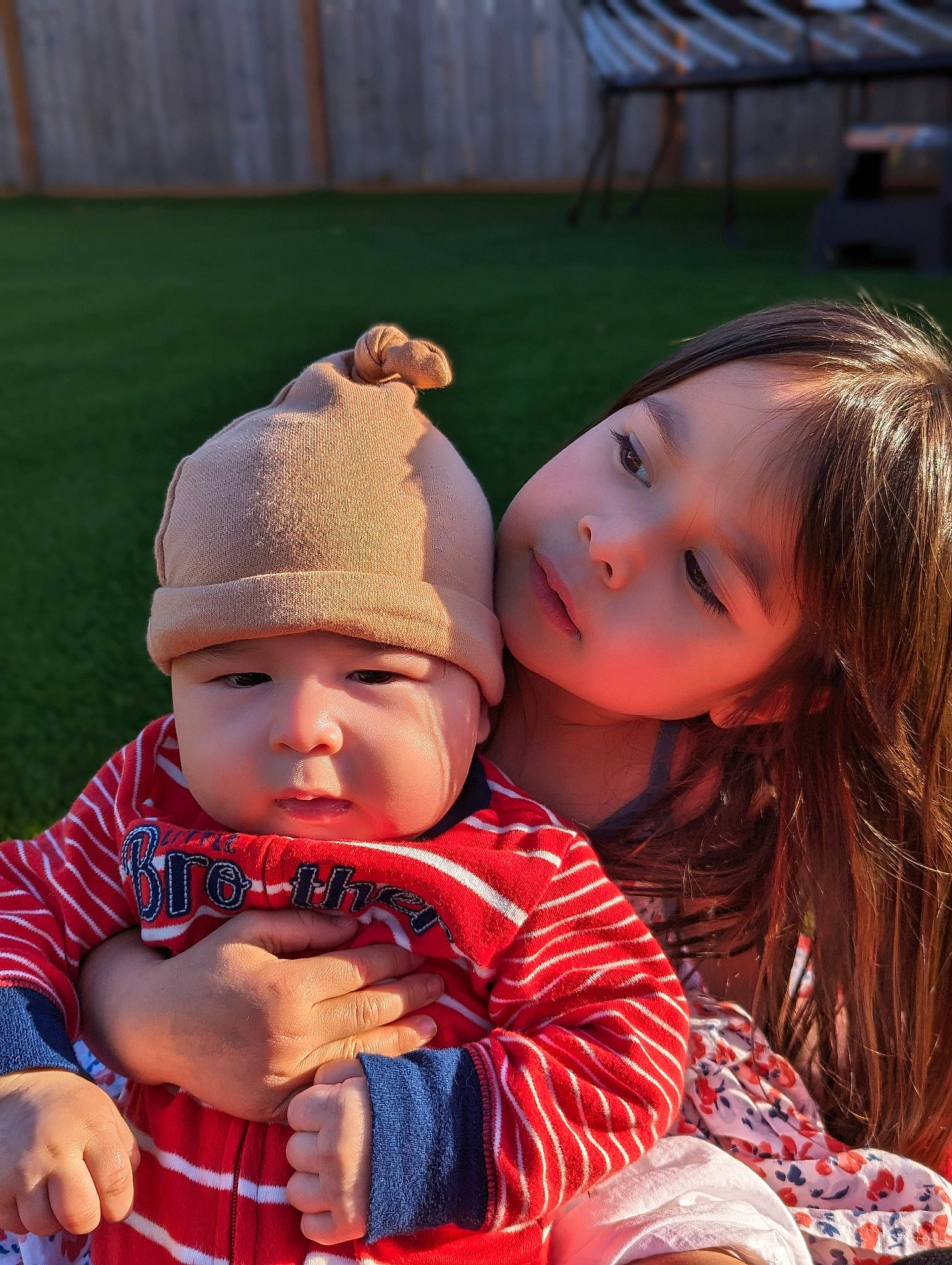 Lily joined the competition — help win amazing prizes! baby, baby_toddler_clothing, cap, child, eye, fun, grass, happy, headwear, knit_cap, leisure, lip, pattern, people_in_nature, person, plaid, play, recreation, sitting, skin