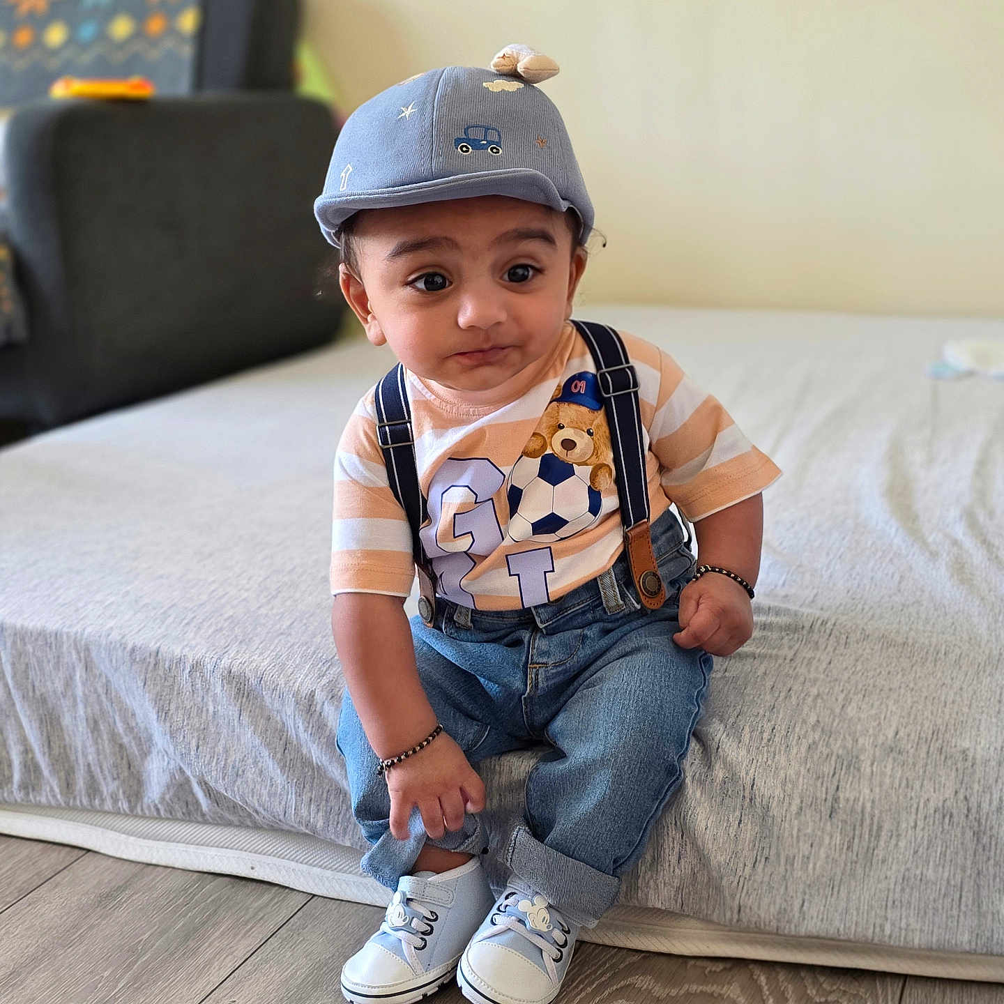 Hiyan joined the competition — help win amazing prizes! bed, bracelet, cap, child, curious, cute, floor, furniture, indoor, jeans, living_room, person, portrait, shirt, sitting, sneakers, suspenders, teddy_bear, toddler, wooden_floor