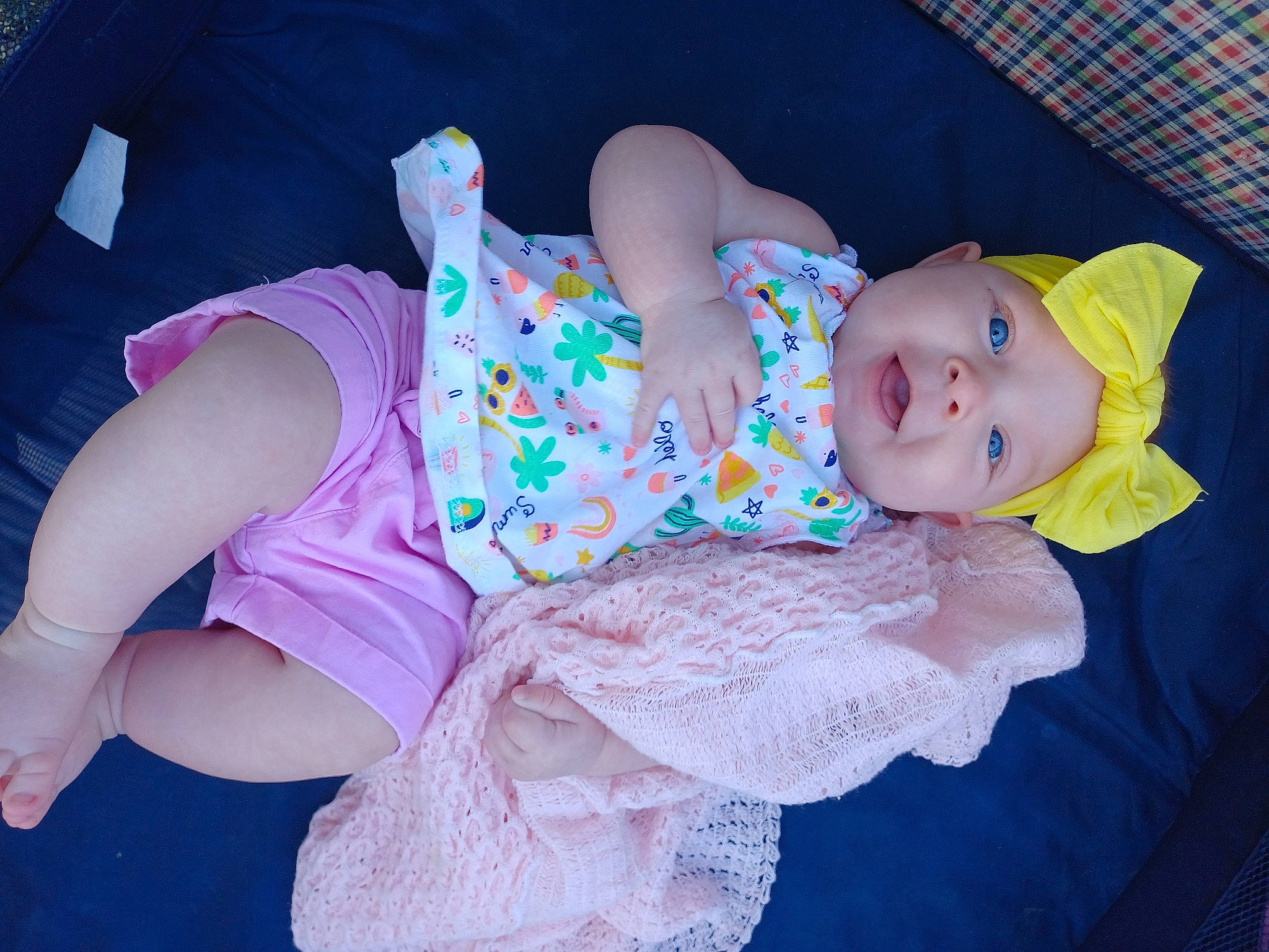 Edelweiss is registered to the contest to win money with this photo: baby, baby_toddler_clothing, comfort, finger, hand, headwear, human_body, human_leg, knee, lap, leg, pattern, person, pink, purple, shorts, sitting, skin, sock, textile