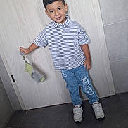 Liham a rejoint le concours — aidez-le/la à gagner de superbes lots ! child, boy, smile, striped_shirt, blue_jeans, sneakers, indoor, door, floor_tiles, holding_object, casual_clothing, happy, portrait, standing, short_hair, young, person, clothing, footwear, light_background