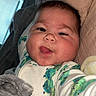 Sage joined the competition — help win amazing prizes! baby, child, face, tongue_out, onesie, snail_pattern, bed, blanket, cozy, indoor, selfie, cute, playful, infant, person, young_child, sleepwear, head, cheeks, smiling