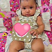 Selena is registered to the contest to win money with this photo: baby, child, bow, card, colorful, quilt, blanket, cute, hand, legs, face, eyes, clothing, sitting, indoor, infant, portrait, expression, soft, comfortable