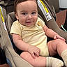 baby, car_seat, chair, child, clothing, cute, furniture, happy, head, indoor, infant, person, portrait, seat, skin, smiling, socks, table, yellow_onesie, young