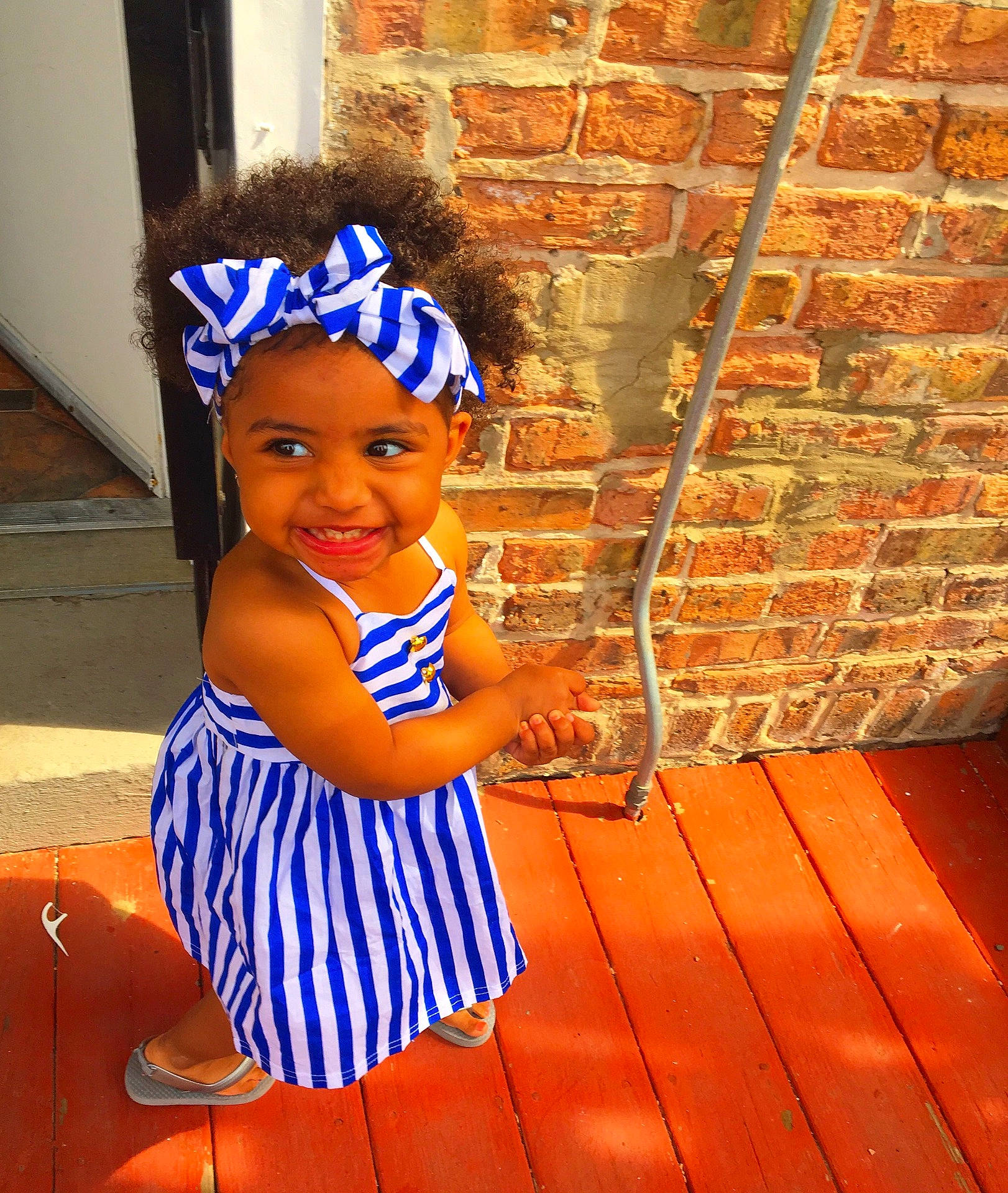 Zoriah is registered to the contest to win money with this photo: blue, child, day, fun, girl, happiness, headwear, joy, pattern, person, product, smile, toddler, vacation