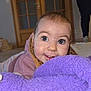 baby, blanket, child, clothing, cozy, curious, door, eyes, face, floor, head, home, indoor, infant, person, portrait, purple, smile, soft, warm