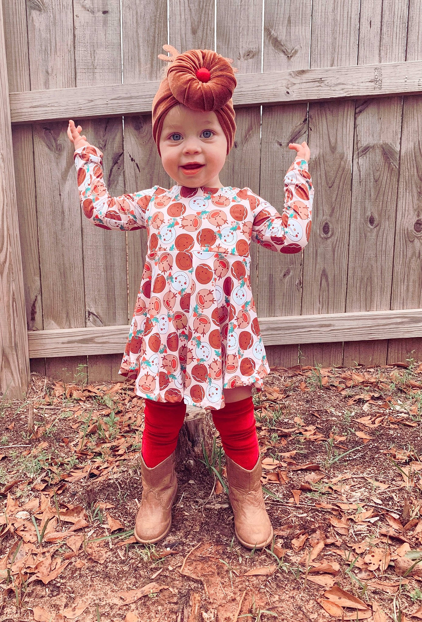 Liana is registered to the contest to win money with this photo: arm, baby_toddler_clothing, child, dress, finger, fun, grass, happy, headwear, magenta, pattern, people_in_nature, person, pink, plant, red, sleeve, smile, standing, tints_and_shades