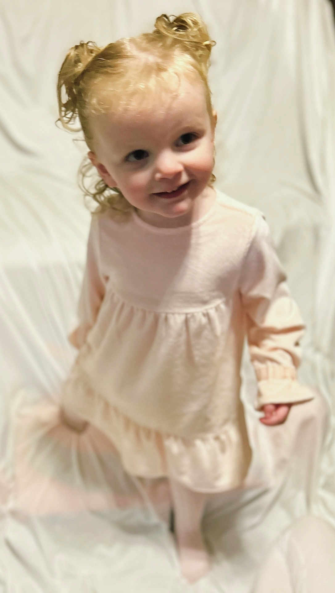 Alyvia joined the competition — help win amazing prizes! toddler, child, girl, curly_hair, pigtails, pink_dress, tights, smile, standing, white_background, portrait, cute, young_child, indoor, soft_lighting, fashion, innocence, person, happy, childhood