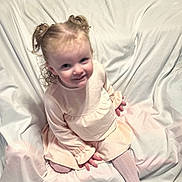 Alyvia joined the competition — help win amazing prizes! toddler, child, girl, pigtails, curly_hair, dress, tights, smile, sitting, white_background, fabric, portrait, cute, indoors, soft_lighting, baby, young_child, playful, happy, person