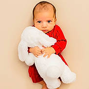 Aaryan joined the competition — help win amazing prizes! baby, infant, red_clothing, stuffed_animal, white_bunny, plush_toy, cute, portrait, child, soft_texture, barefoot, innocence, looking_at_camera, indoor, neutral_background, small_hands, young_child, cozy, adorable, toddler