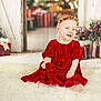 Brooklyn joined the competition — help win amazing prizes! baby, celebration, child, christmas, cute, decorations, festive, fluffy_rug, happy, headband, holiday, holiday_decor, indoor, person, portrait, presents, red_dress, sitting, smile, smiling
