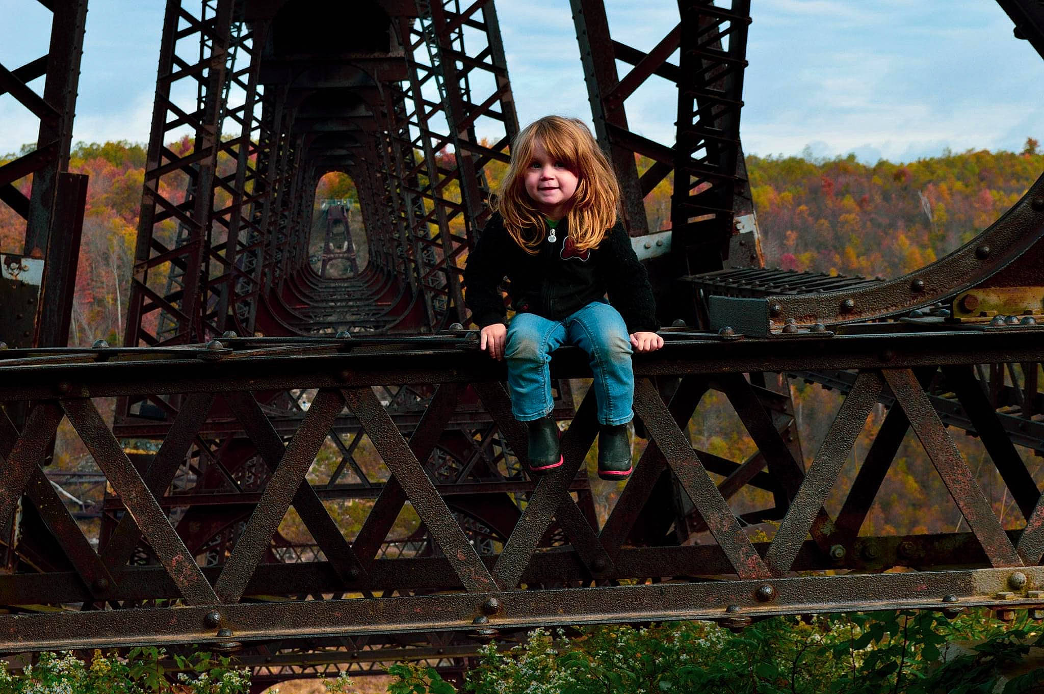 Leda joined the competition — help win amazing prizes! bridge, forest, fun, grass, jacket, joy, landscape, leisure, metal, natural_environment, nonbuilding_structure, person, plant, recreation, sitting, sky, smile, spring, sunglasses, symmetry