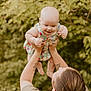 Oaklie joined the competition — help win amazing prizes! baby, child, person, adult, arms, floral_dress, smiling, happy, outdoor, greenery, leaves, nature, tattoo, holding, lifting, cute, playful, summer, portrait, skin