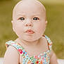 Oaklie is registered to the contest to win money with this photo: baby, child, portrait, face, blue_eyes, curious_expression, floral_dress, colorful_clothing, outdoor, grass, soft_focus, cute, infant, skin, summer, nature, person, sitting, head, closeup