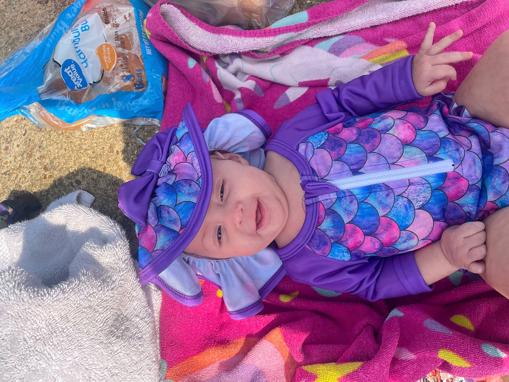 Brynlee is registered to the contest to win money with this photo: baby, baby_products, baby_toddler_clothing, child, comfort, electric_blue, fashion_accessory, fun, headwear, linens, magenta, pattern, person, pink, product, purple, sitting, textile, toddler, tree