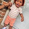 toddler, child, smile, hat, bucket_hat, shorts, striped_shirt, tigger_character, hand_holding, adult_hand, brick_wall, window_blinds, white_socks, outdoor, happy, person, clothing, footwear, portrait, standing
