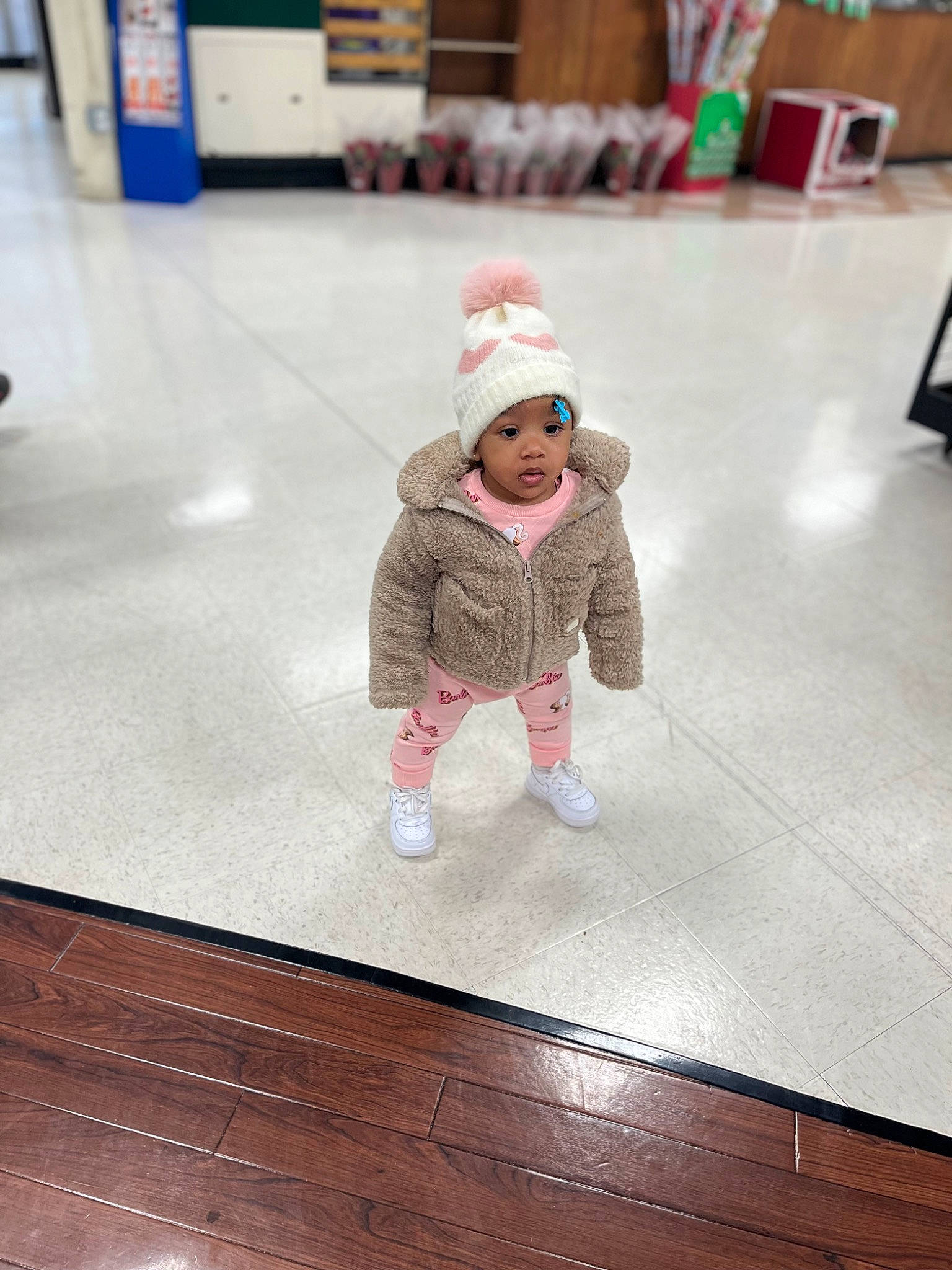Celanna is registered to the contest to win money with this photo: asphalt, baby, baby_toddler_clothing, beanie, cap, child, floor, flooring, fun, hardwood, headwear, jacket, leisure, magenta, person, recreation, road_surface, sidewalk, standing, toddler
