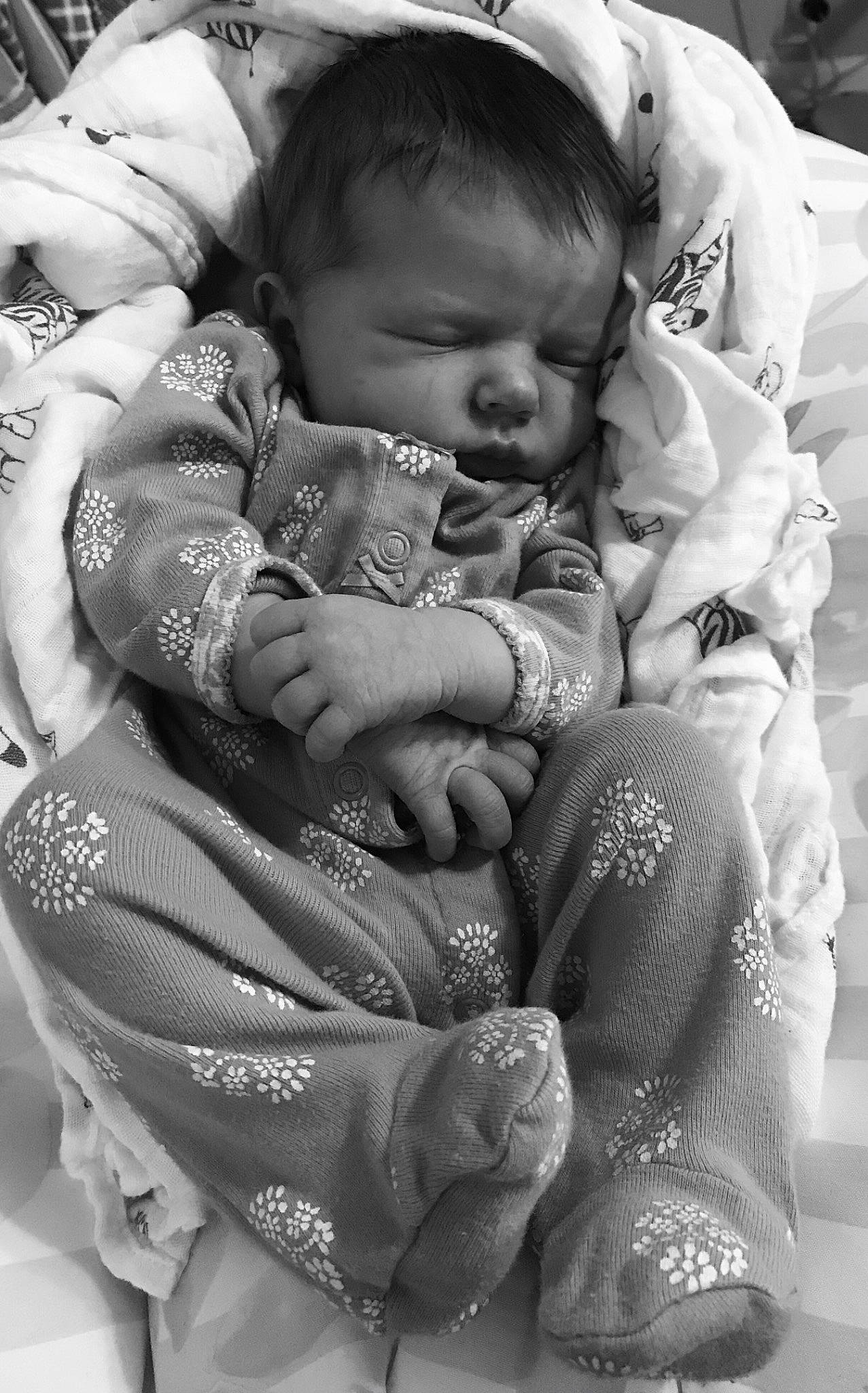 Joanna is registered to the contest to win money with this photo: baby, baby_toddler_clothing, black, black_and_white, cheek, face, gesture, hairstyle, hand, happy, human_body, iris, monochrome, organ, person, photograph, skin, style, textile, toddler