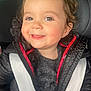 Gabriella participe au concours pour gagner de l'argent avec cette photo : baby, black_jacket, car_seat, child, closeup, cute, expression, face, hair, happy, indoors, jacket, person, portrait, red_trim, seatbelt, smile, toddler, warm_clothing, young_child