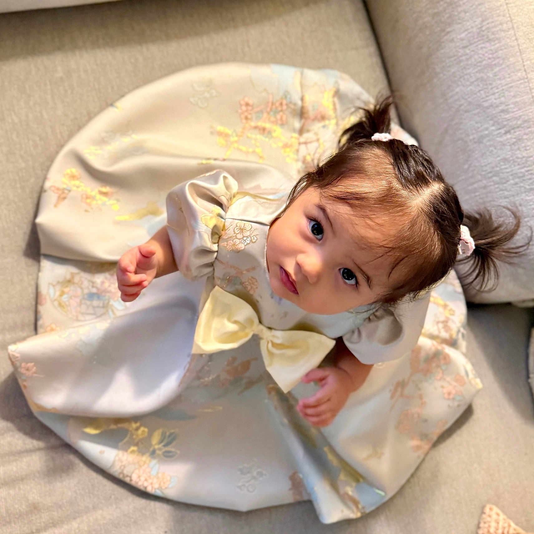 Madison Ava is registered to the contest to win money with this photo: baby, blanket, clothing, crawling, cushion, dress, face, fashion, formalwear, gown, happy, head, homedecor, person, photography, portrait, robe, sitting, sleeve, smile