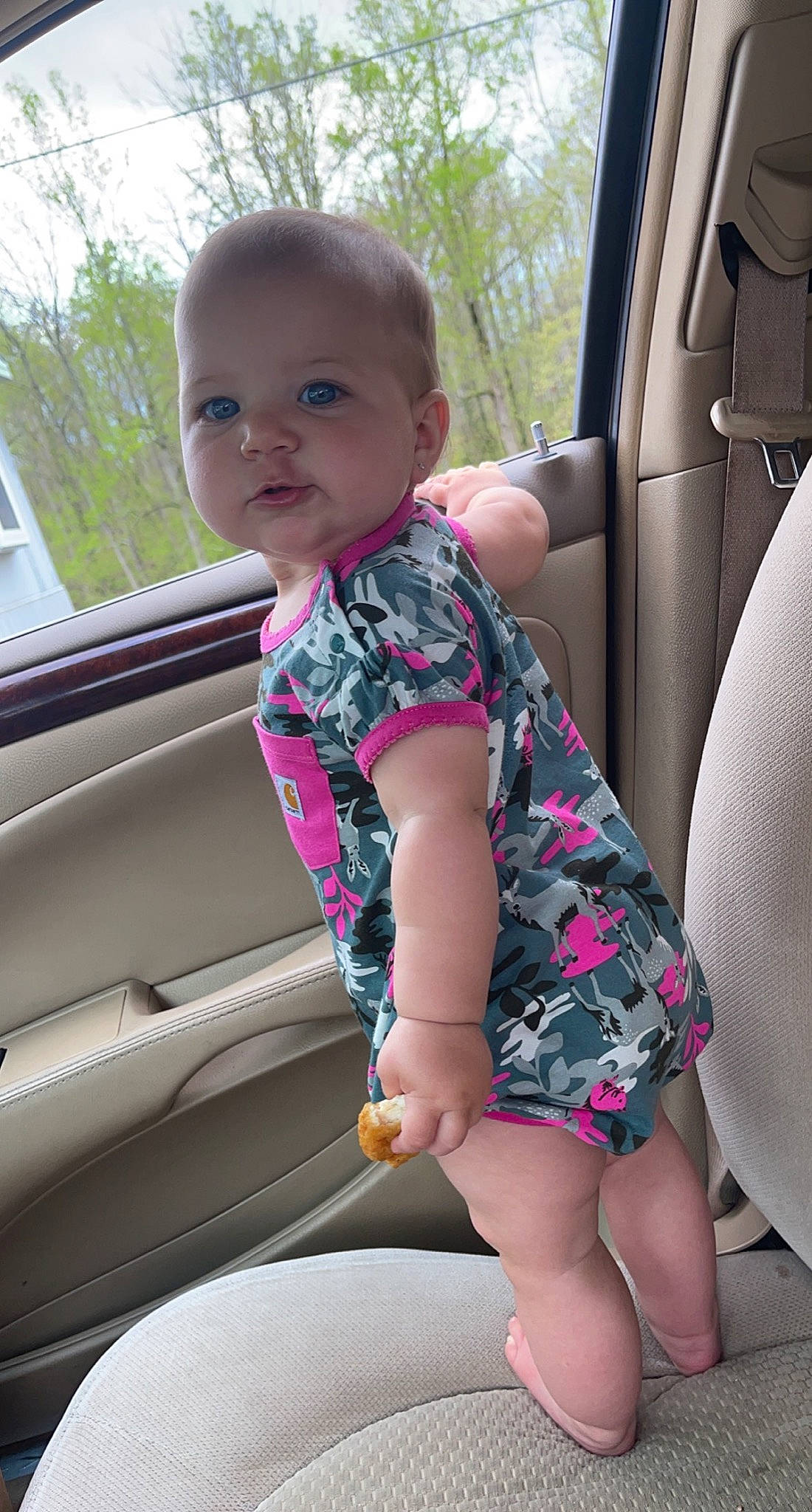 Hadlee joined the competition — help win amazing prizes! automotive_exterior, baby_toddler_clothing, car, car_seat, car_seat_cover, comfort, face, finger, head, leg, motor_vehicle, person, pink, product, steering_wheel, thigh, thumb, toddler, tree, vehicle_door