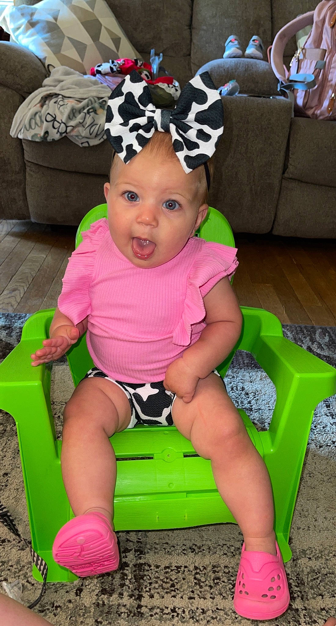 Hadlee is registered to the contest to win money with this photo: baby, baby_toddler_clothing, child, couch, fun, happy, headband, headpiece, headwear, human_leg, knee, leg, leisure, magenta, person, pink, purple, shorts, sitting, surprise