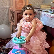 Mirha is registered to the contest to win money with this photo: child, toddler, pink_dress, tiara, toy_car, birthday, balloons, party, celebration, indoor, carpet, blocks, decorations, cute, portrait, girl, play, happy, event, person