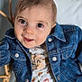 Ernest participe au concours pour gagner de l'argent avec cette photo : baby, child, denim_jacket, cute, smiling, face, eyes, clothing, patterned_shirt, animal_print, wicker_chair, cushion, indoor, portrait, infant, happy, closeup, person, seated, casual