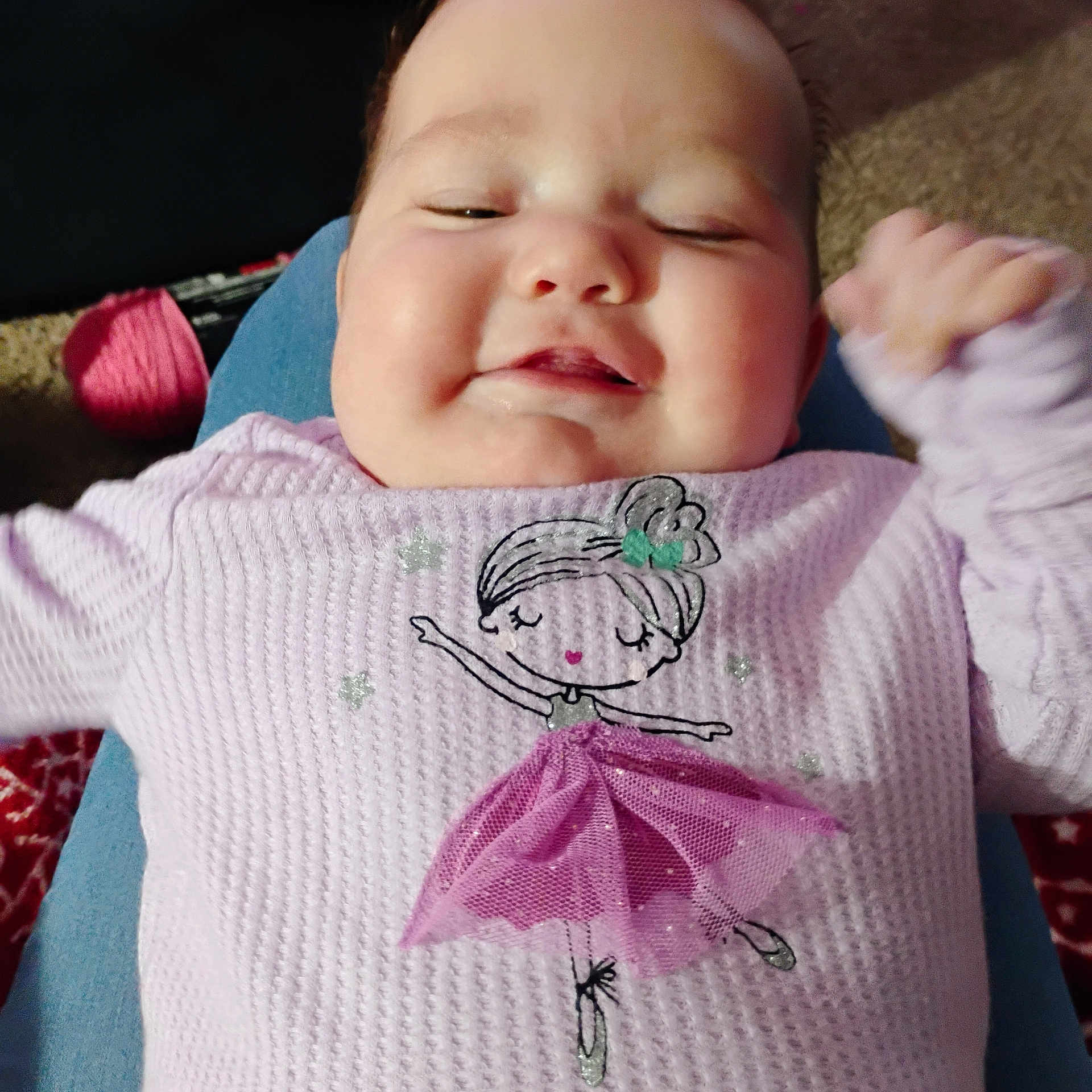 Journey is registered to the contest to win money with this photo: baby, child, smiling, purple_sweater, ballerina_design, infant, face, closeup, cheeks, happy, clothing, toddler, person, portrait, indoor, fabric, hand, carpet, texture, knees