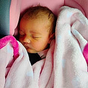 Journey is registered to the contest to win money with this photo: baby, sleeping, blanket, pink, car_seat, infant, child, face, soft, cozy, cute, resting, newborn, wrapped, head, closeup, peaceful, indoors, young, portrait
