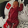 baby, sleeping, onesie, maroon, stars, moons, blanket, puzzle_piece, pacifier, infant, cozy, peaceful, bed, child, footed_pajamas, resting, cute, indoors, soft, young