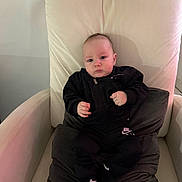 Axel Gael Morera joined the competition — help win amazing prizes! baby, infant, child, armchair, chair, cushion, pillow, black_clothing, hoodie, nike, brand_logo, socks, grip_socks, portrait, indoors, skin, face, hands, eyes, cute