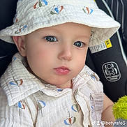 Axel Gael is registered to the contest to win money with this photo: baby, baby_fashion, blue_eyes, bucket_hat, car_seat, child, close_up, clothing, cute, hat, indoor, infant, patterned_clothing, person, plush_toy, portrait, seat, serious_expression, shirt, small_toy