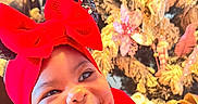 Ruth joined the competition — help win amazing prizes! baby, red_bow, red_dress, smiling, happy, face, infant, christmas_tree, ornaments, holiday, festive, decorations, indoors, cute, child, portrait, toddler, headband, holiday_season, celebration